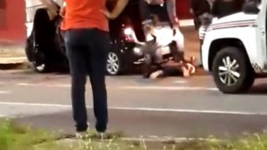 Policias imobilizam suspeitos, vítima está no canteiro central de camisa laranja